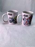 Front view of both mugs showing Stormtrooper, Yoda, Kylo Ren graphics