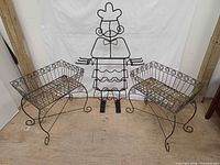 Two wrought iron planters and chef wine rack overall view