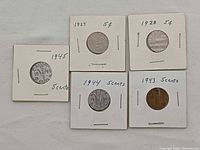 Five coin flips showing dates 1927, 1928, 1943, 1944, 1945