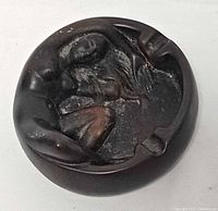 Top view of resin ashtray showing reclining nude female figure