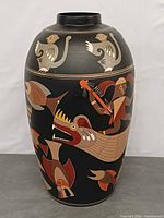 Front view showing fish, warrior in canoe, black background