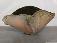 oblique view showing organic folded rim and exterior glaze