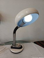 Lamp upright showing shade interior, stem, base and dimmer knob