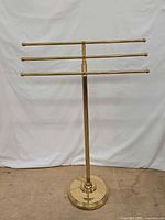Full view front of brass towel rack stand