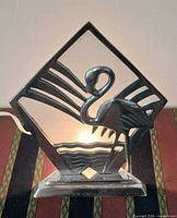 Lamp lit showing aluminium flamingo silhouette and glass