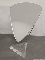 Front angle of freestanding Nike display mirror showing mirror shape, metal rods, acrylic base