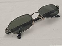 Front view of Persol 2075-S sunglasses showing gunmetal frame and green lenses
