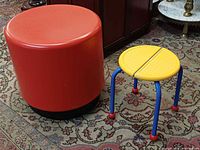 Large red stool and small yellow IKEA stool side by side