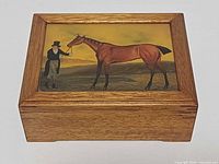 Closed box, front view showing painted lid