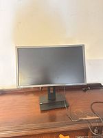 Front view of Acer B246HL monitor on stand with cable visible