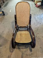 Front view of bentwood rocking chair showing cane back and seat