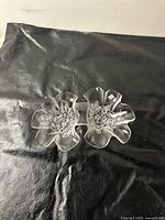 Top view of clear pressed glass double divided candy dish showing floral motif and overall form