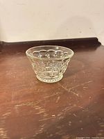 Oblique view of clear pressed glass bowl showing overall shape and pattern