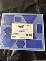 Front view of sealed tray showing assorted blue geometric shapes and product label