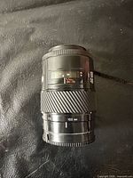 Lens front angled view showing zoom ring, focal length markings and wear