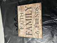 Front view of rectangular plaque showing text and metal scroll