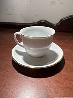 Single teacup on saucer showing design, color and trim