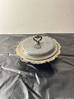 Dish with lid on showing overall form and handle