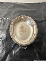 dish interior showing oval shape, scroll rim, tarnish