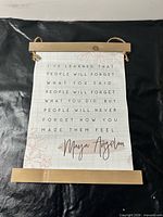 Front view showing full Maya Angelou quote and wood slats