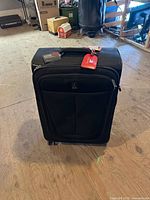 Front view showing Travelpro logo, exterior pocket, wheels