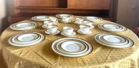 Full 39-piece bone china set arranged on table showing plates, cups and saucers