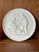 Front view of round white bisque porcelain relief plaque