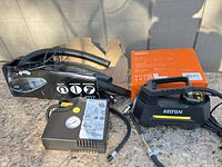Full lot showing air compressor, vacuum, hoses and both boxes
