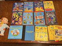 All books and plush laid out on table