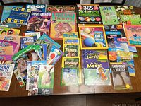 All books spread on table showing variety and quantity