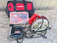 Group shot of circular saw, jigsaw, hand tool kit and Husky bag