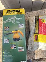 Eureka HotShot retail box alongside Rubbermaid mop head pack