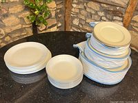 Stacks of dinner plates, bowls and salad plates on countertop