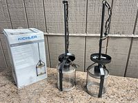Box with Kichler branding and both pendant lights standing upright