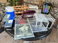 Lot overview showing cooler, wine carrier, wood rack, bar mats, jug, wire organizers