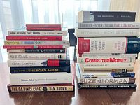 Two stacks of books showing spines for travel, self-help, finance, fiction and biographies