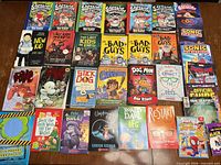 Top-down view of entire lot showing all books laid out in four rows