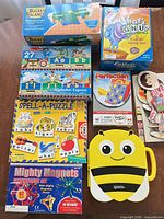 Group shot of all boxed games, bee carry case and extra pieces