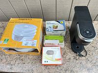 All five items grouped: Keurig brewer, Presto dehydrator box, food chopper box, handheld vacuum box, Farberware set