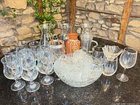 Full lot overview on countertop showing goblets, punch set, carafes, vase, ice bucket