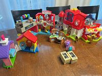 Overview of all playsets, pony figures and boxed items on table