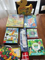 Group shot of all eight boxed games, counting bears bag and flip cards