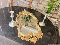 Mirror and candlesticks on countertop