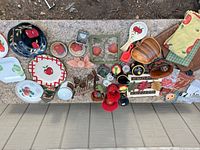 Overhead view of entire lot showing apple motif plates, bowls, mugs, wooden boards, plaques, textiles and lights
