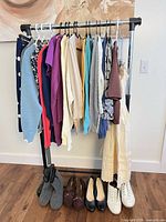 full view of clothing rack with garments and shoes
