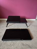 Two black collapsible laptop desks folded and opened