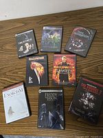 Eight DVD cases arranged on wooden surface showing front cover artwork