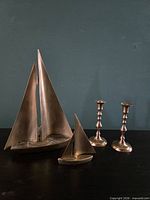 All items grouped: two brass sailboats and two candlesticks