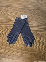 Gloves laid flat showing full view and decorative stitching