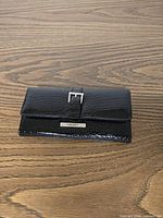 Front view showing buckle accent and logo plate